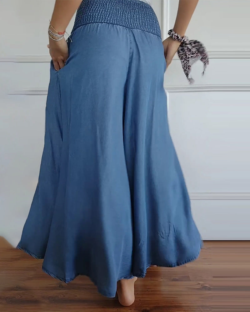 High-waisted wide-leg trousers with smocked elastic waistband, denim blue, back view.