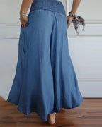 High-waisted wide-leg trousers with smocked elastic waistband, denim blue, back view.