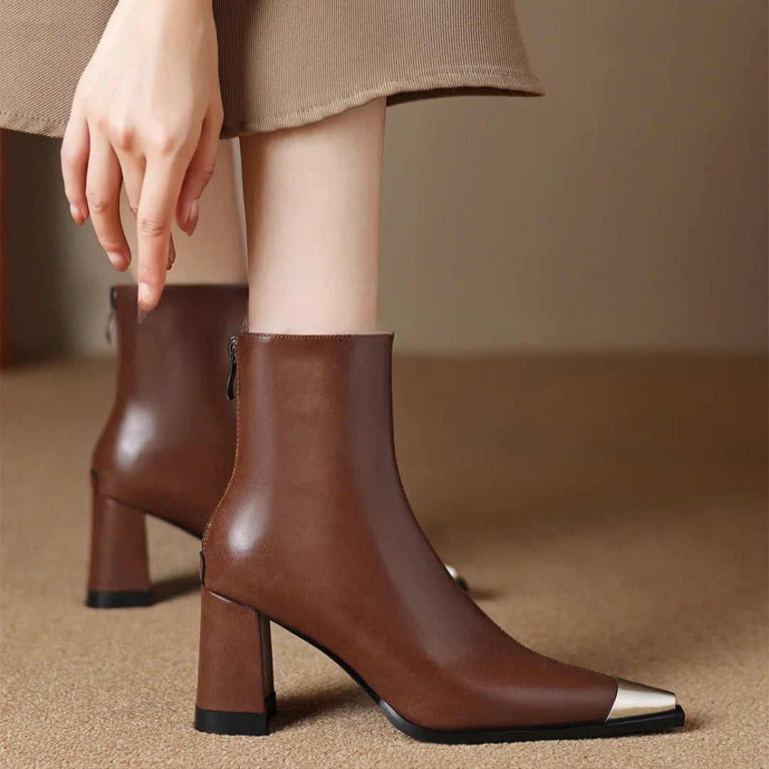 Women’s brown pointed-toe ankle boots with block heel and side zipper, metallic toe detail