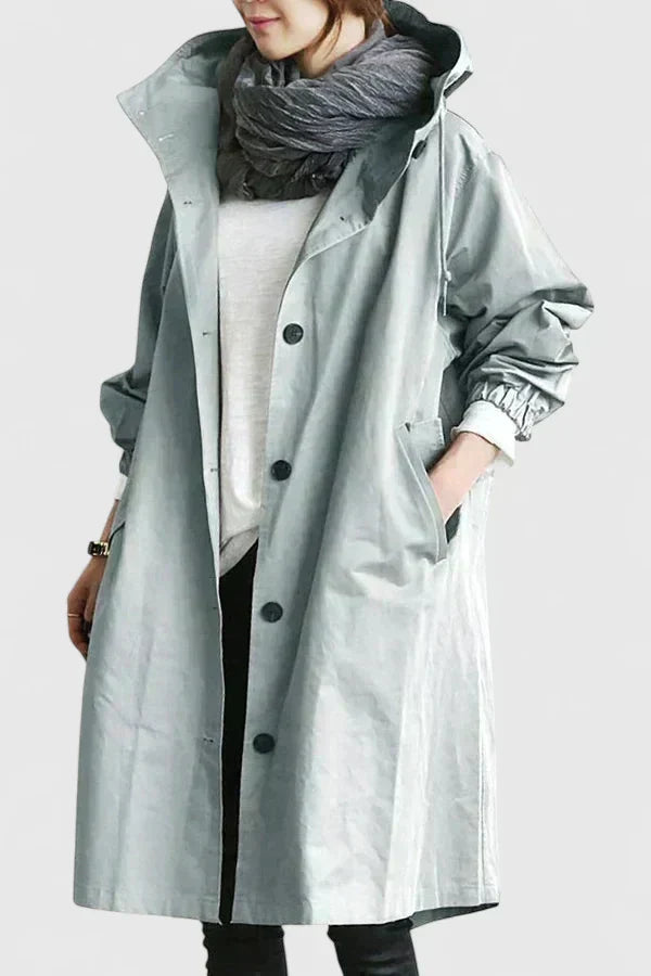Light blue-gray hooded coat with button front and wide sleeves, cuff details