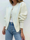 Ivory knit open-front cardigan with long pearl trim and frayed hem