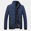 Blue padded jacket with stand collar, front zipper, and two side pockets