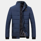 Blue padded jacket with stand collar, front zipper, and two side pockets