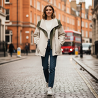 Two-tone windbreaker jacket on model with layered front and snap placket, olive and cream