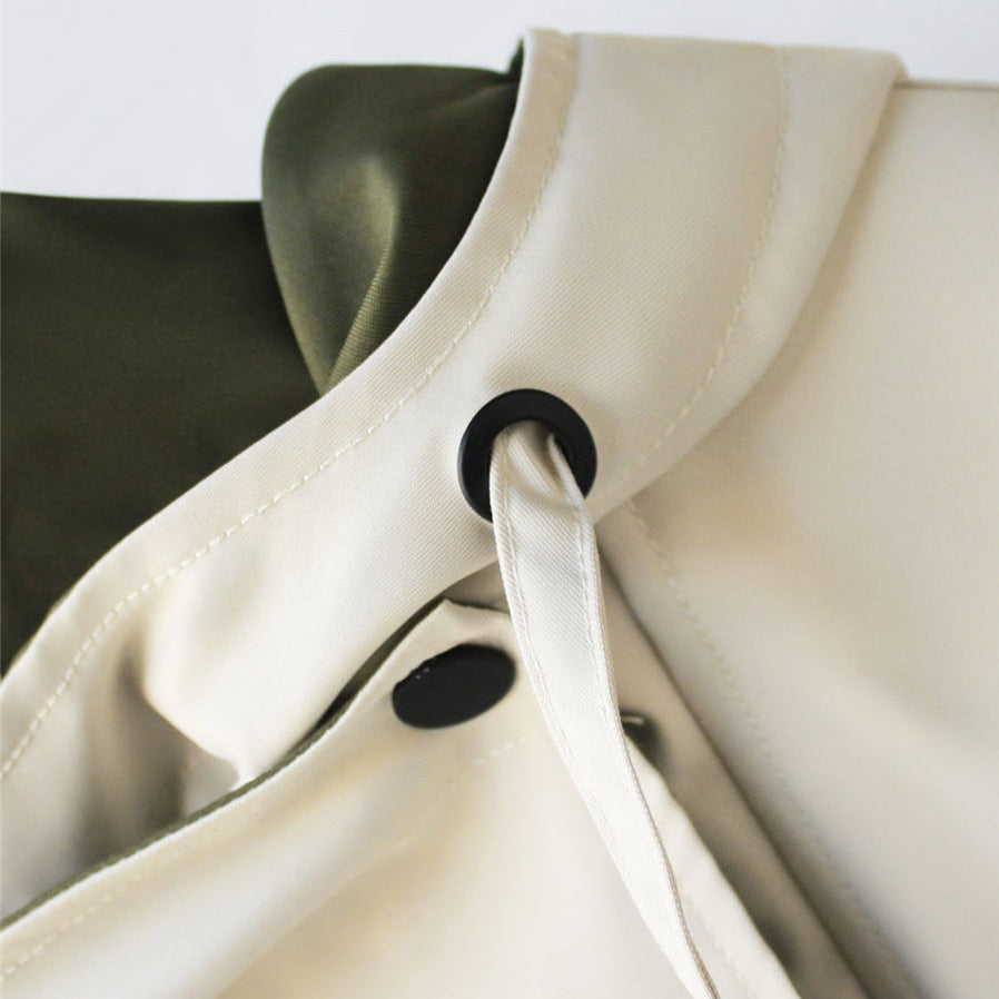 Windbreaker jacket collar with black toggle drawstring on cream and olive panels