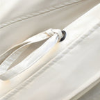 Windbreaker jacket sleeve drawstring with black-tipped cord on cream fabric