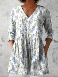 White long V-neck blouse with blue floral print, gathered waist, 3/4 sleeves
