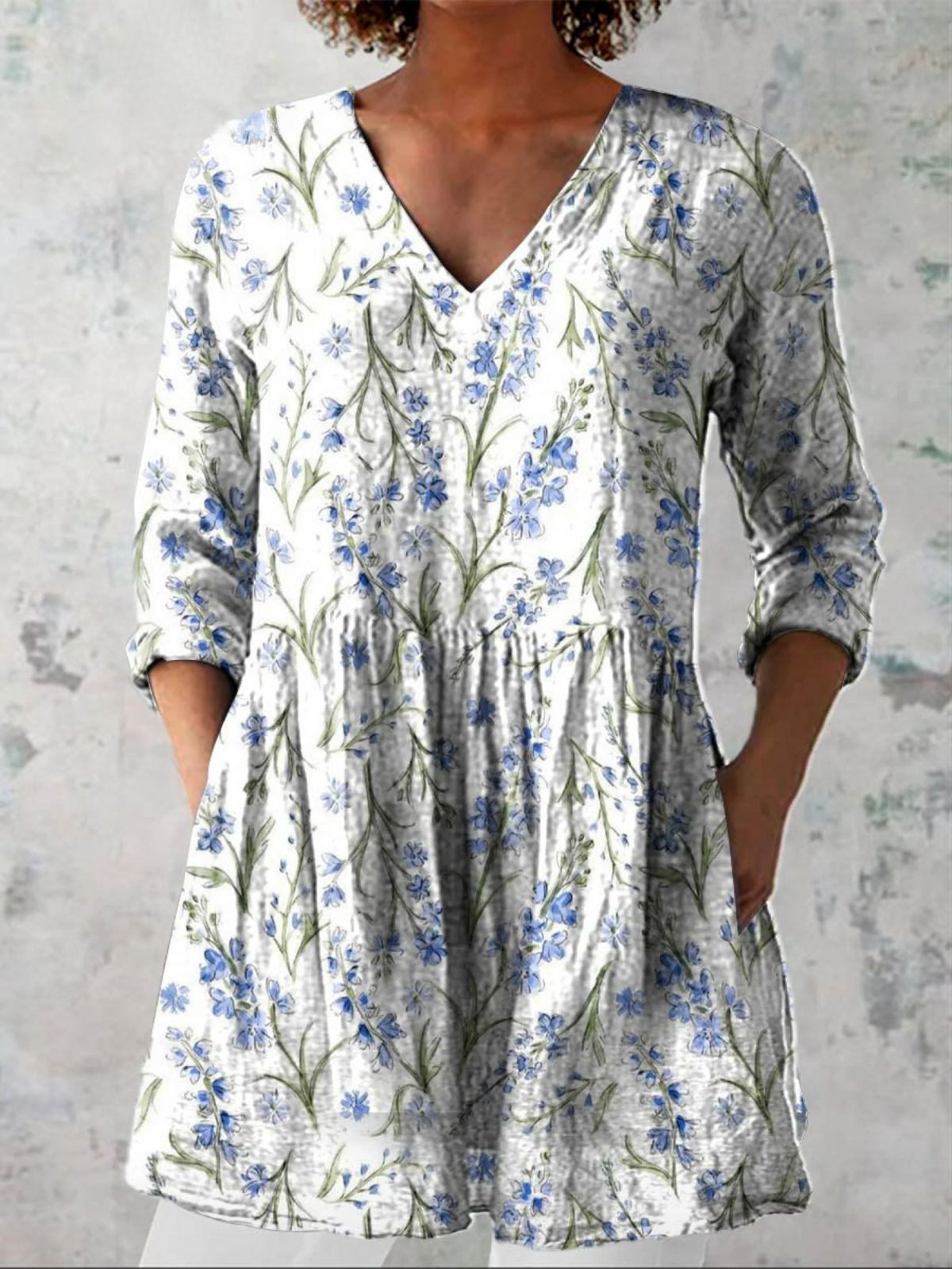 White long V-neck blouse with blue floral print, gathered waist, 3/4 sleeves
