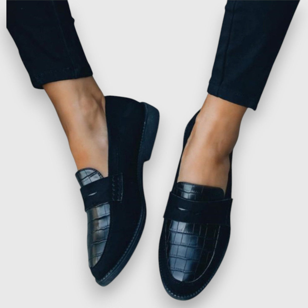 Women's black leather flat slip-on loafers with croc texture and strap across top