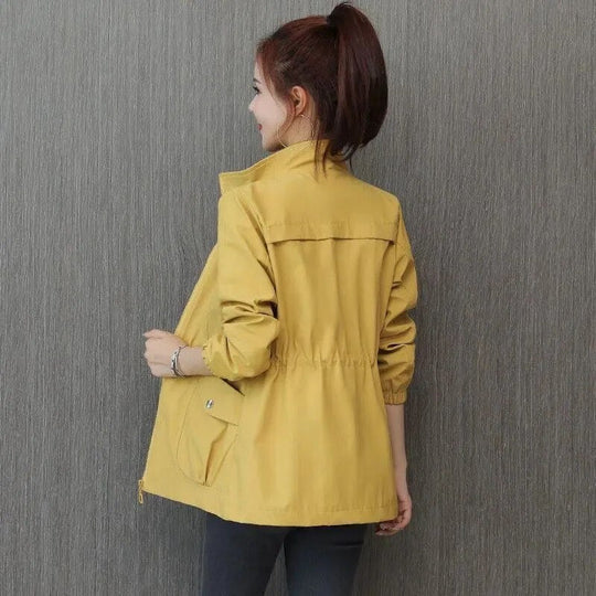 Yellow high-neck full-zip jacket with elastic waist and flap pockets, back view