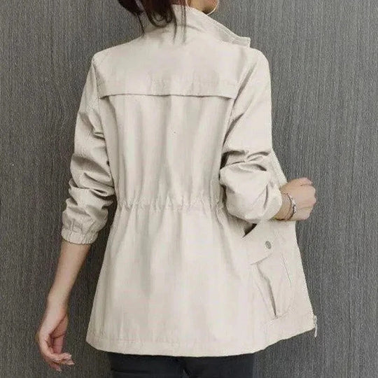 Light cream high-neck full-zip jacket with elastic waist and two flap pockets, back view