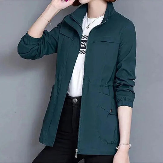 Dark teal high-neck full-zip jacket with chest pockets and ribbed cuffs