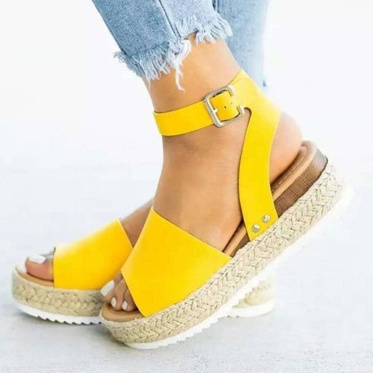 Yellow open-toe wedge sandals with ankle strap and jute-wrapped platform