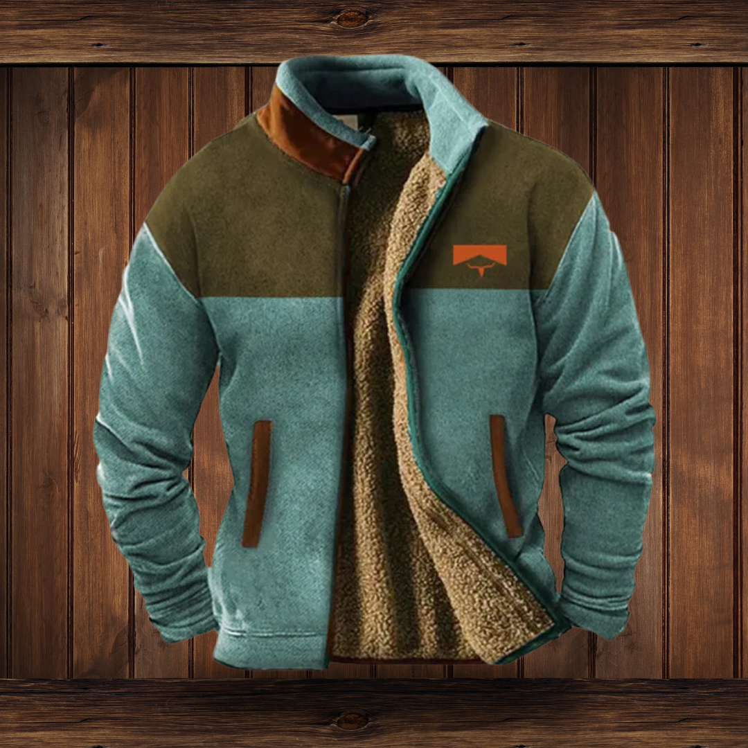 Two-tone merino fleece jacket with patterned sleeves, teal main body, zip front.