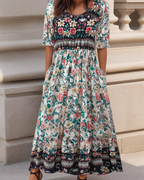 Floral midi dress with short sleeves, teal and cream with dark patterned border hem