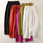 Assorted wide-leg trousers in black, orange, magenta, olive, and white with elastic waistband