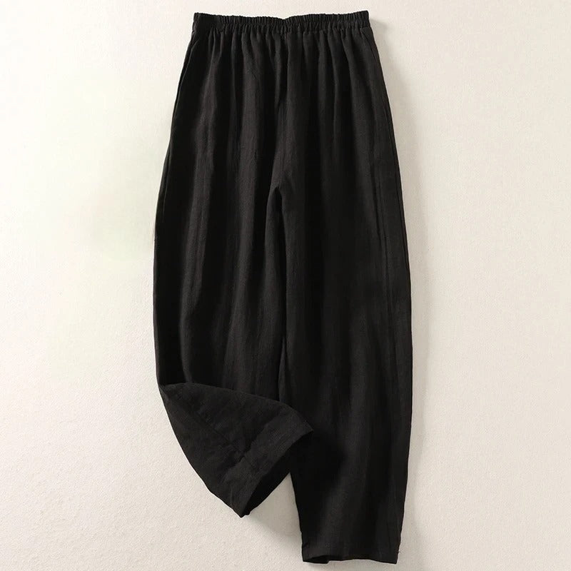 Black wide-leg tailored trousers with elastic waistband and relaxed fit