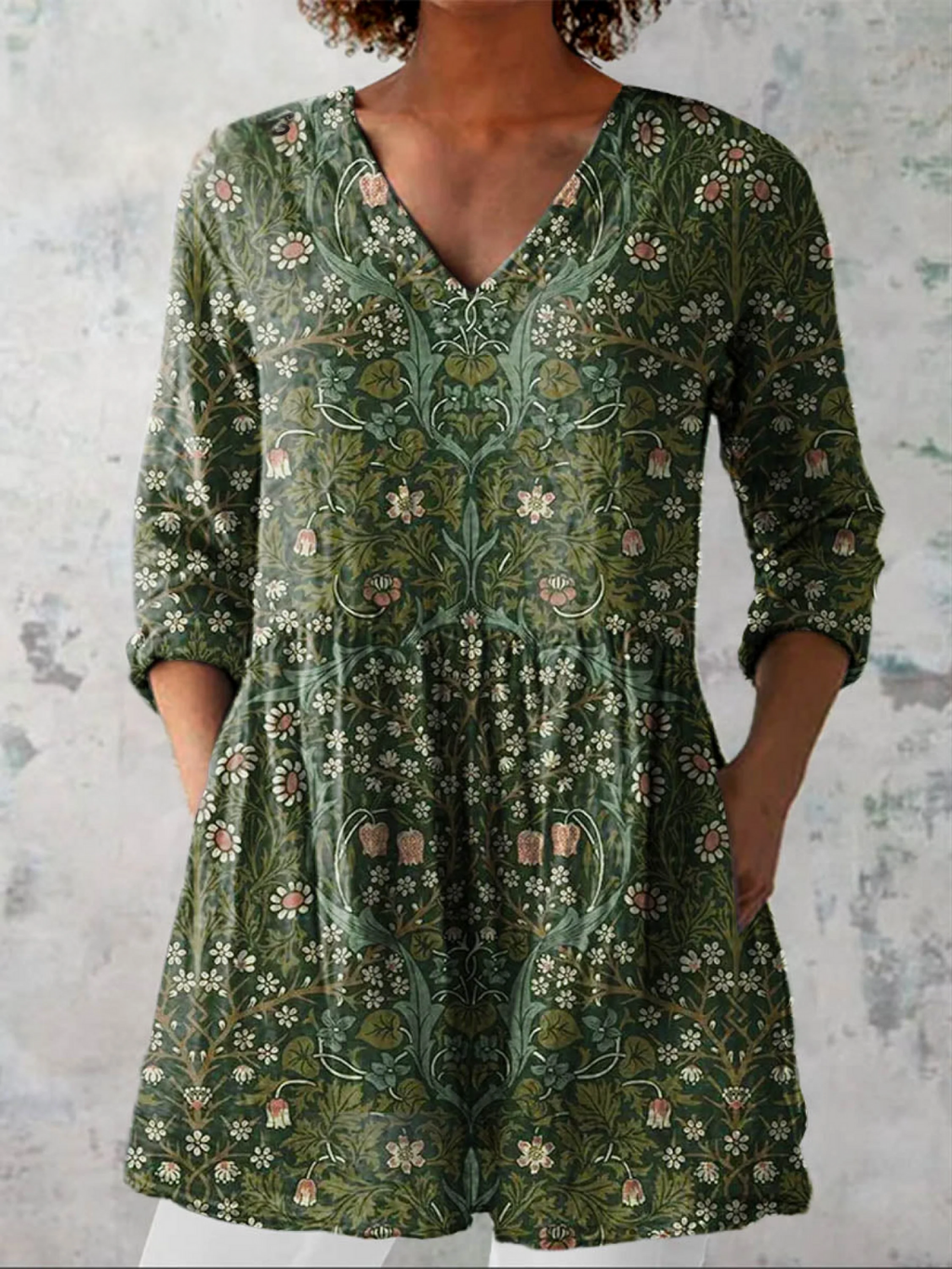 Green floral V-neck blouse with 3/4 sleeves and gathered relaxed fit