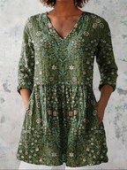 Green floral V-neck blouse with 3/4 sleeves and gathered relaxed fit
