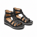Black strappy wedge sandals with open-toe cutouts, back pull tab, and rhinestone-edged sole