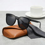 Oversized square sunglasses, glossy black frames with dark tinted lenses, UV400