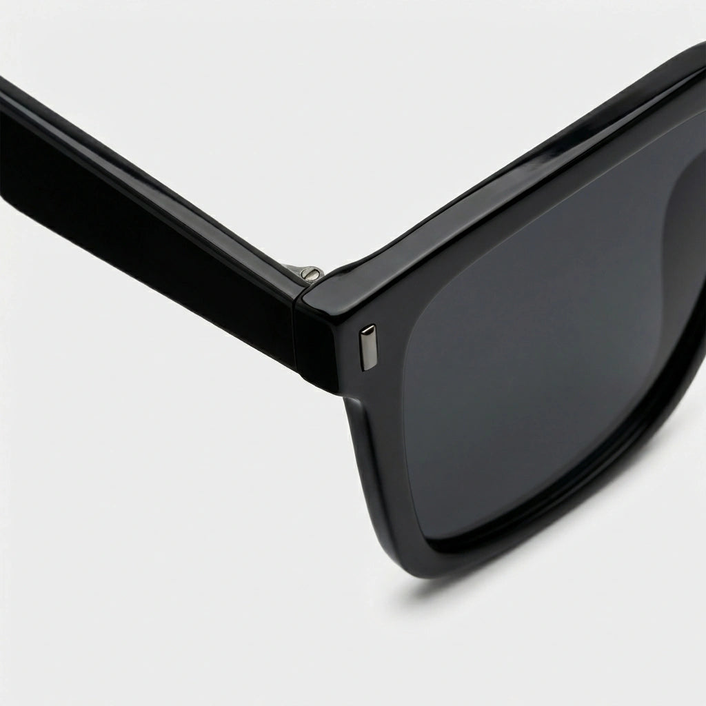 Oversized square sunglasses, black frame with dark lens and small metal detail