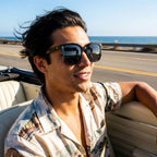 Oversized square sunglasses on a person, glossy black frames with dark tinted lenses