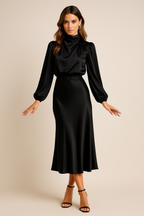 Black satin midi dress with high neck, long balloon sleeves, and belted waist