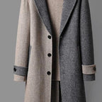Dual-tone wool coat close-up showing button front, contrast panels, ribbed collar