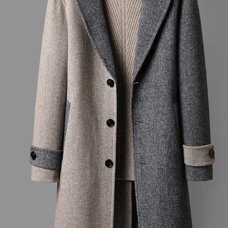 Dual-tone wool coat close-up showing button front, contrast panels, ribbed collar