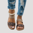 Beige open-toe flat sandals with cross strap and leopard print footbed