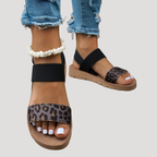Black open-toe cross-strap flat sandals with leopard print toe band