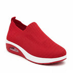 Red lightweight breathable walking trainers with white soles and slip-on knit upper
