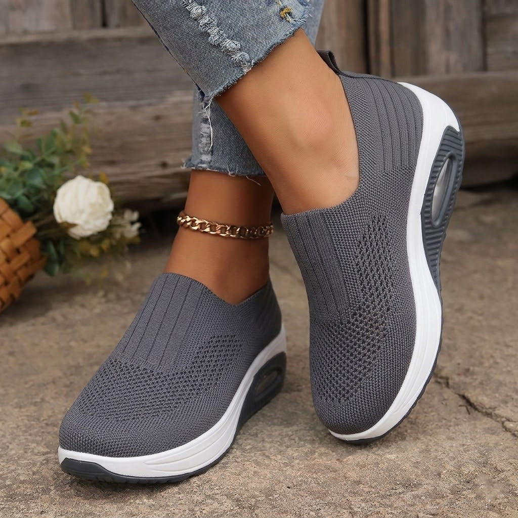 Grey lightweight breathable slip-on trainers with white sole and air-cushion heel
