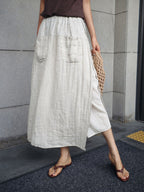 Cream linen culottes with wide legs, elastic waist, and side pockets