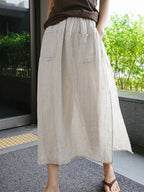 Cream linen culottes, wide-leg silhouette with side pockets and elastic waist