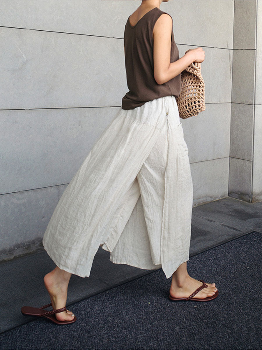 Cream linen culottes with flowing wide legs and side pockets, elastic waist