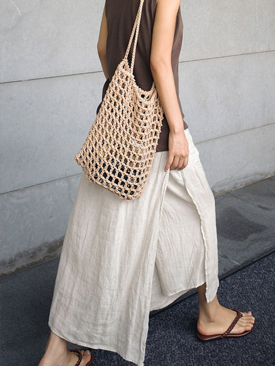 Cream linen culottes with wide legs, side pockets, and elastic waistband