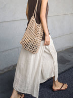 Cream linen culottes with wide legs, side pockets, and elastic waistband