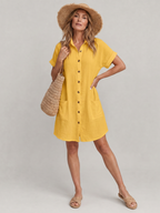 Yellow knee-length short-sleeve dress with button front and front pockets