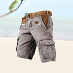 Gray cargo shorts with tan webbed belt, side cargo pockets, relaxed fit