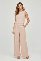 Light pink sleeveless wide-leg jumpsuit with round neck, worn by model
