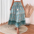 Long tiered cotton-blend skirt with floral print, elastic waistband, border trim.