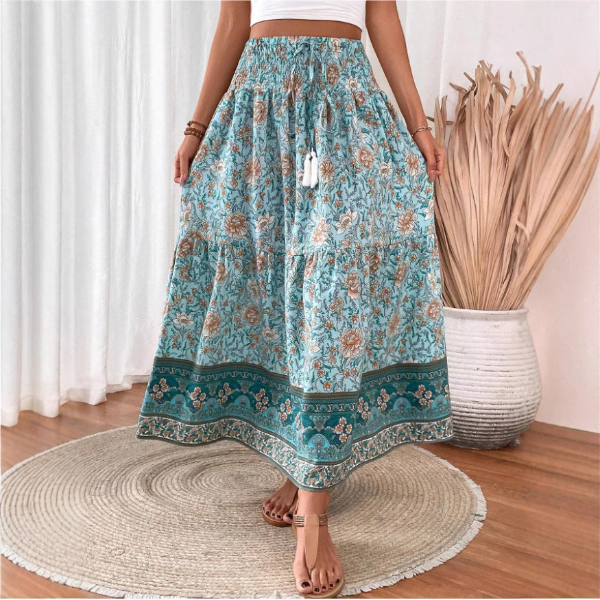 Long tiered cotton-blend skirt with floral print, elastic waistband, border trim.