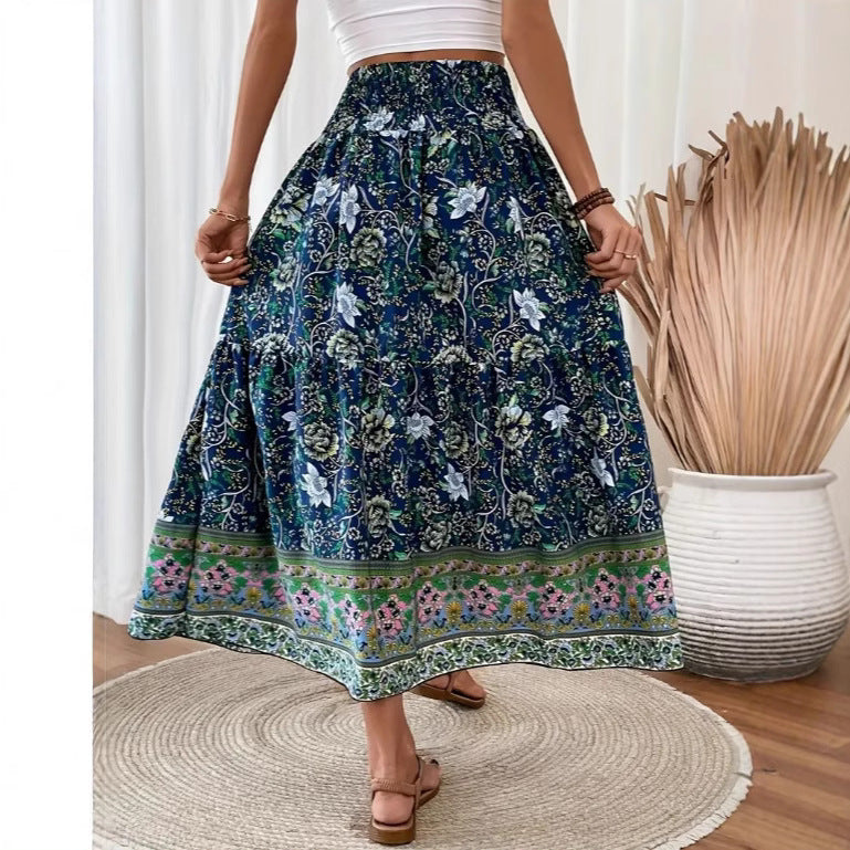 Long tiered skirt with dark blue floral print, elastic waistband, decorative border.