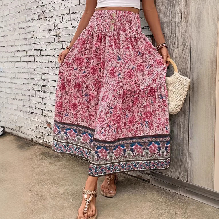 Long tiered skirt with pink floral print, elastic waistband, patterned hem border.