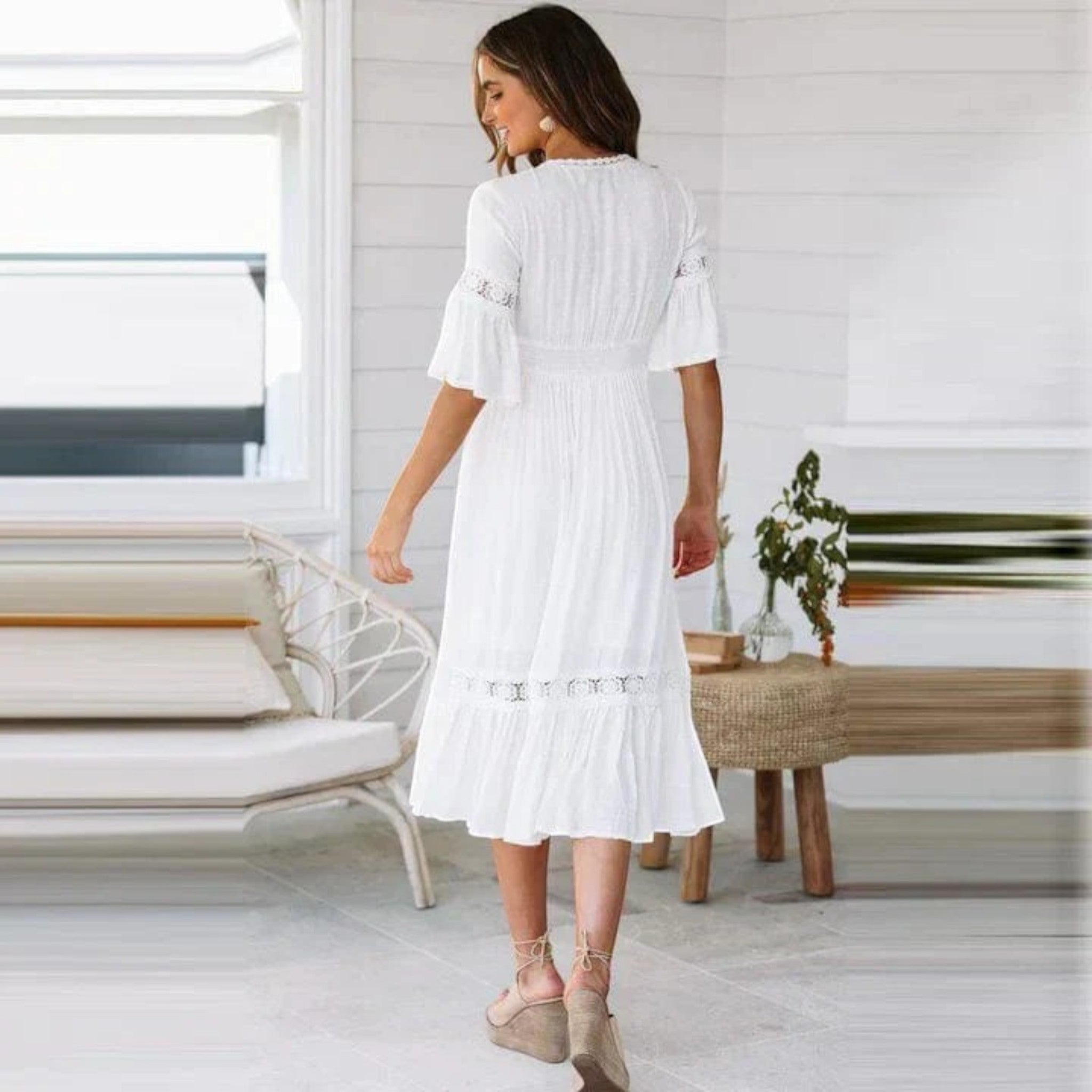 White bohemian midi dress back view with tiered hem and embroidered lace trim