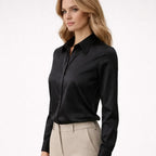 Black button-front blouse with point collar and long sleeves, side profile