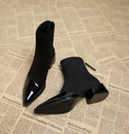 Black suede ankle boots pair with glossy pointed toe and chunky block heel