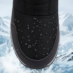Black mid-calf snow boots with textured upper and water beading on the fabric